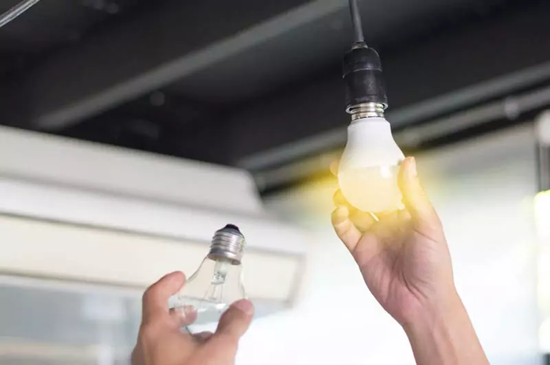 Close-up of a glowing LED bulb during a manual testing process